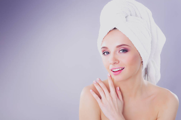 Beautiful woman with a towel on his head on a gray background - Photo, Image