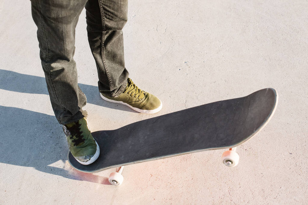 Close-up of skateboarders foot while skating in skate park - Φωτογραφία, εικόνα