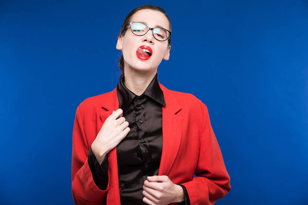 seductive girl in red jacket and glasses - Foto, afbeelding