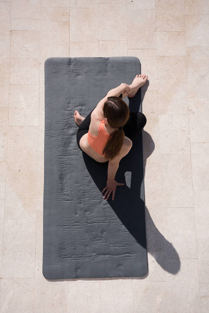 woman doing morning yoga exercises top view - Foto, Imagem