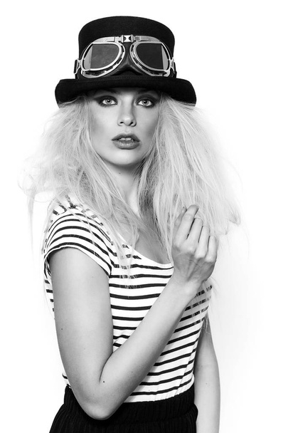 Pretty blonde girl wearing hat and strange sunglasses, monochrome - Fotó, kép