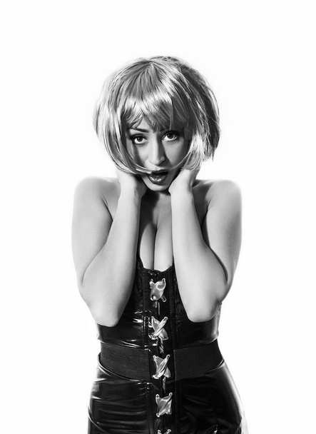 Surprised pop girl monochrome portrait wearing latex dress and wig - Photo, Image