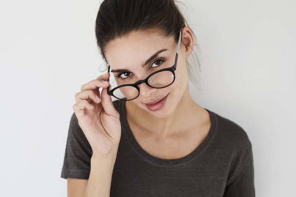 woman looking over spectacles - Fotografie, Obrázek