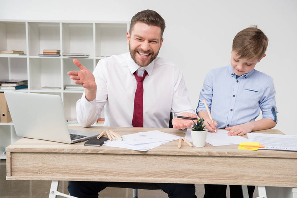 Businessman with son at office - Photo, Image
