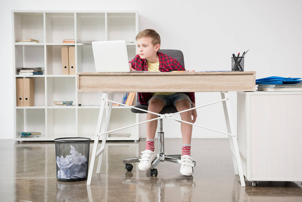 schoolboy using laptop at office - Photo, Image