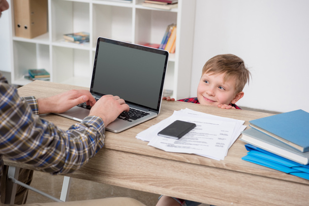 Businessman with son at home office - Photo, Image
