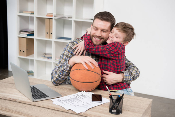 Businessman with son at home office - Фото, зображення