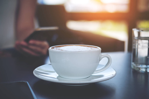 woman using smart phone and coffee - Фото, зображення