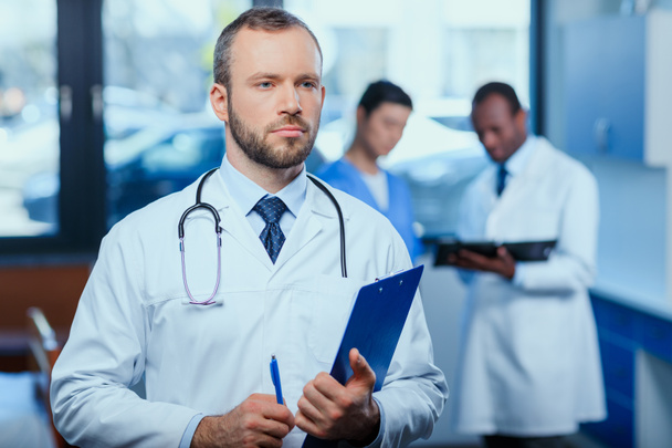 confident doctor with folder - Photo, Image