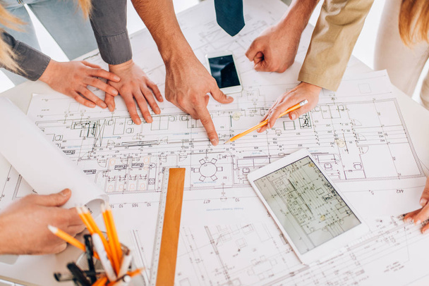 successful architect reviewing blueprints - Фото, изображение