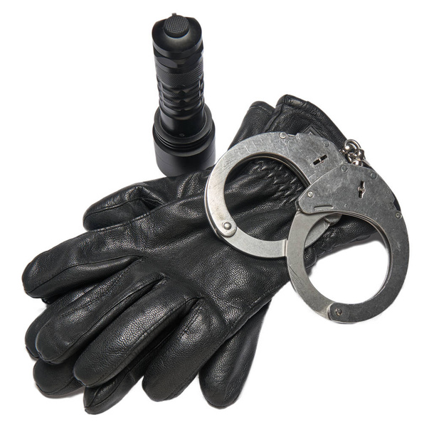 Γερμανική αστυνομία χειροπέδες, δερμάτινα γάντια και ένα φως πυρσών που απομονώνονται σε λευκό φόντο. - Φωτογραφία, εικόνα