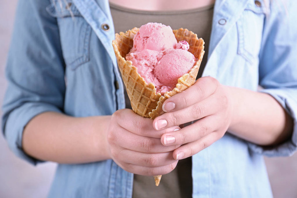 Woman holding cone with ice cream  - Фото, зображення