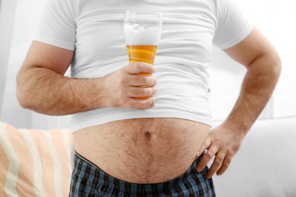 Man with big belly holding beer  - Фото, зображення