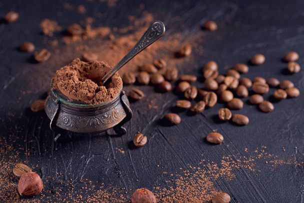 Hazelnut, coffee beans and cocoa powder in dark background. - Photo, Image