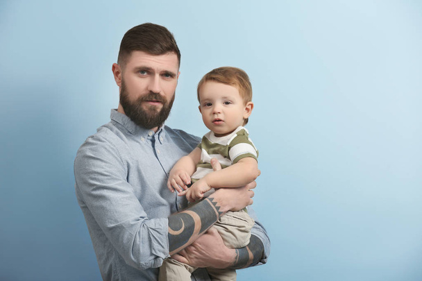 young man holding little boy - Valokuva, kuva