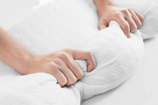 Female hands on orthopedic pillow - Foto, Imagen