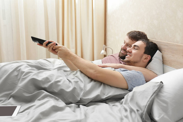 Gay couple lying on bed   - Φωτογραφία, εικόνα