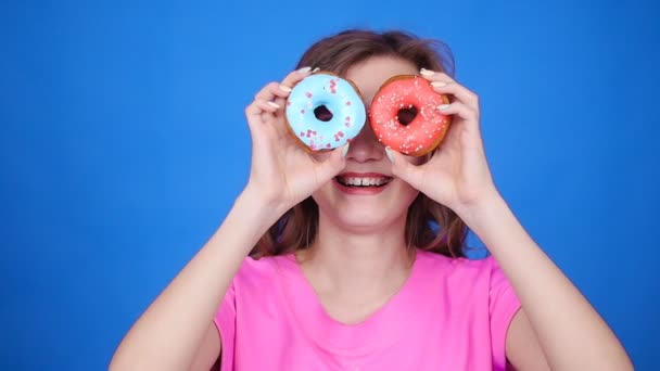 Beauty woman taking colorful donuts. Funny joyful girl with sweets - Footage, Video