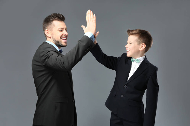 Father and son dressed in suits  - Фото, зображення