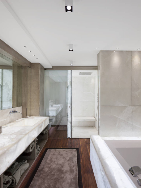 Modern bathroom with marble and parquet, nobody - Foto, afbeelding