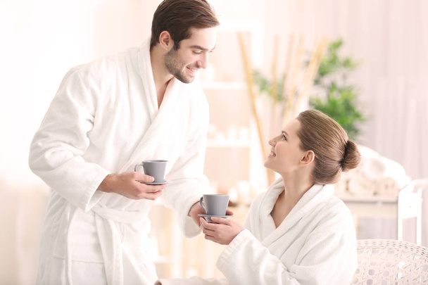 Young happy couple drinking tea  - 写真・画像