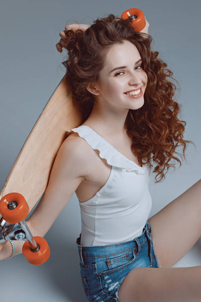 hipster girl with skateboard  - 写真・画像
