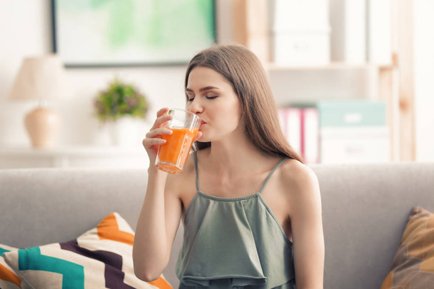 Young woman tasting juice - Foto, afbeelding