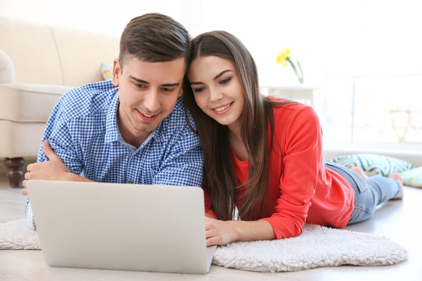 Happy young couple with laptop  - Φωτογραφία, εικόνα