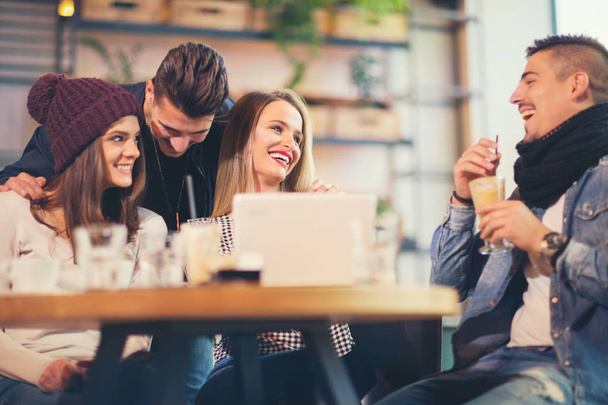 Group of young people sitting in a coffee shop having fun - Фото, зображення