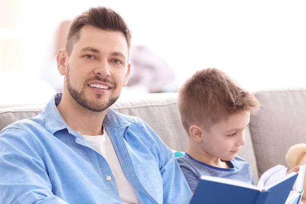 Dad and son reading interesting books   - Photo, image
