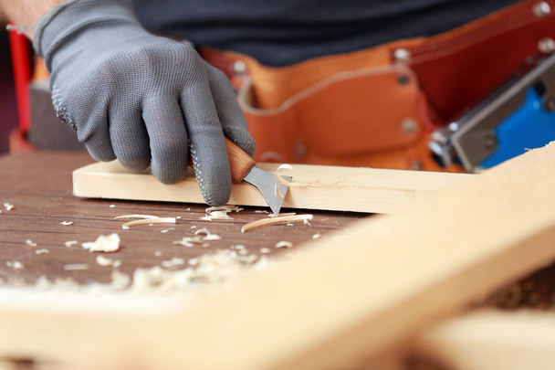 Hand of carpenter with cutter - 写真・画像
