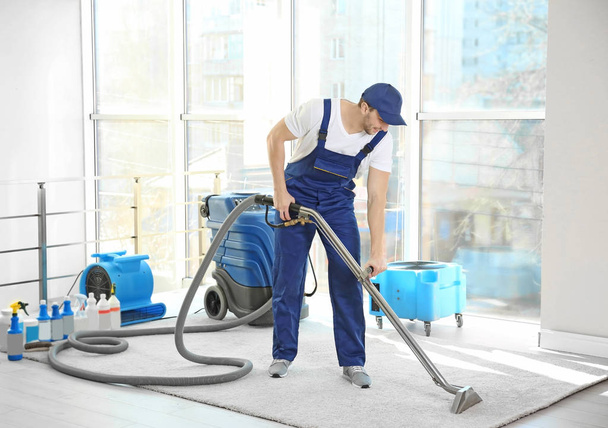 Dry cleaners employee removing dirt  - Fotó, kép