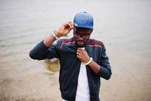 Portrait of stylish african american man on sportswear, cap and  - Фото, зображення