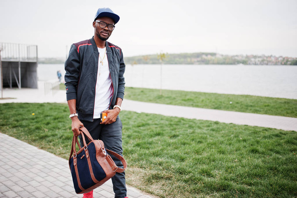 Portrait of stylish african american man on sportswear, cap and  - Fotó, kép