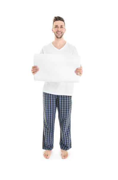 Young man with orthopedic pillow   - Фото, изображение