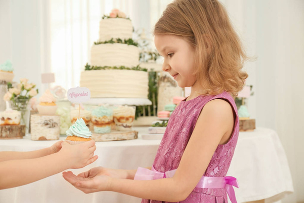 girl giving cupcake to friend - Photo, Image