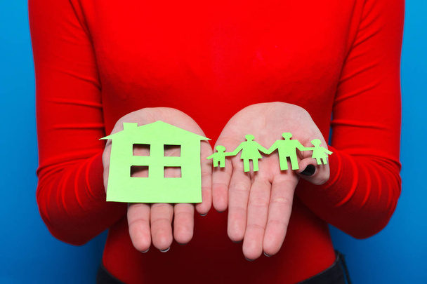 closeup of womans cupped hands showing paper man family - Photo, image