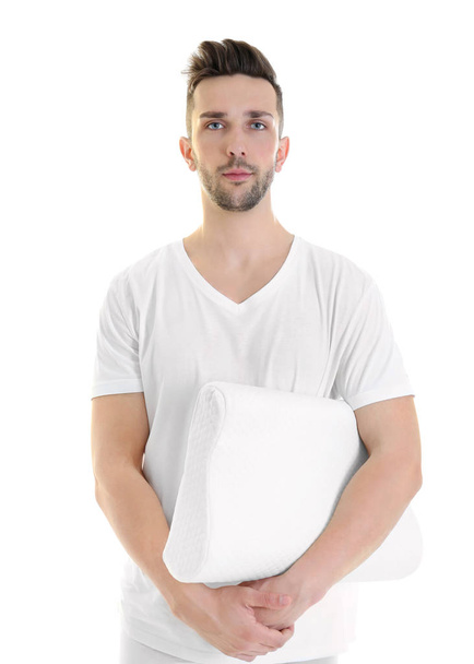 Young man with orthopedic pillow   - Foto, afbeelding
