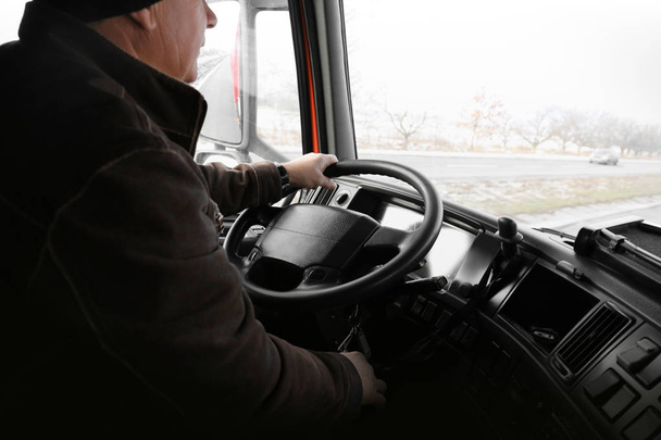 Elderly man driving big modern truck - Foto, afbeelding