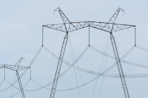 High-voltage power lines against the blue sky. - Photo, Image
