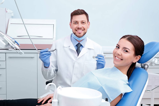 Dentist with patient in clinic - Фото, изображение