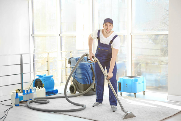 Dry cleaners employee removing dirt  - Valokuva, kuva