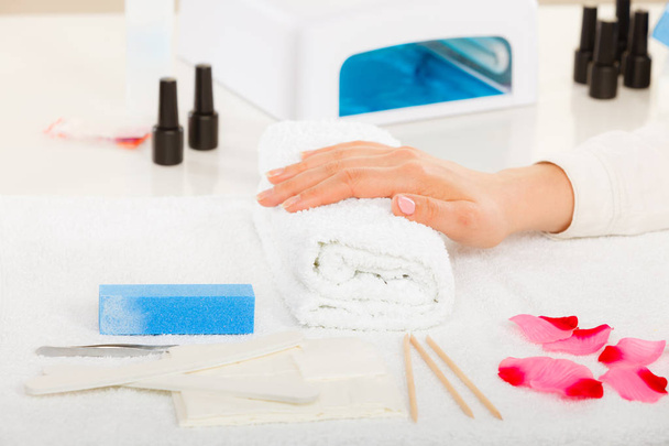 Woman hand on towel, next to manicure set - Foto, immagini