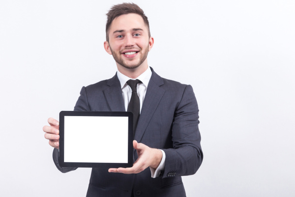 Young businessman with tablet in hands - Foto, Bild