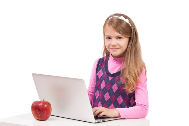 schoolgirl working on laptop - Φωτογραφία, εικόνα