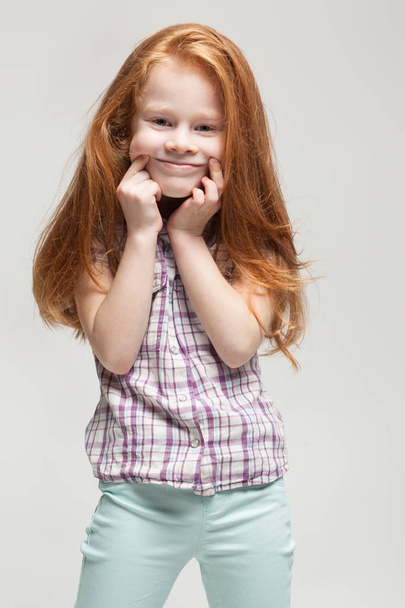Cute redhead girl making faces - Fotó, kép