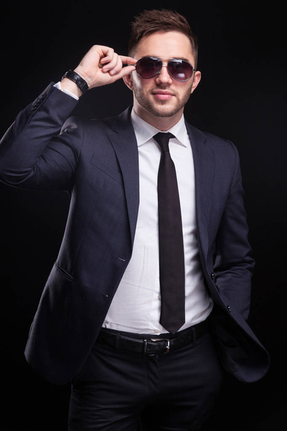 Young confident businessman in sunglasses - 写真・画像