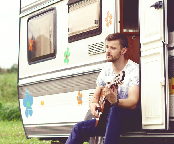 handsome bearded guy playing guitar - 写真・画像