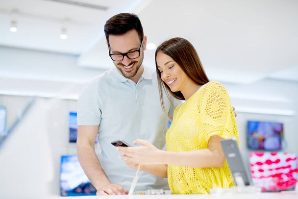 young couple in technics store - Photo, Image