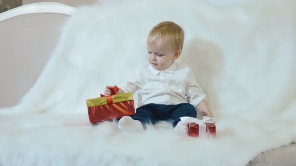A small handsome child is holding a red box in hands - Filmmaterial, Video